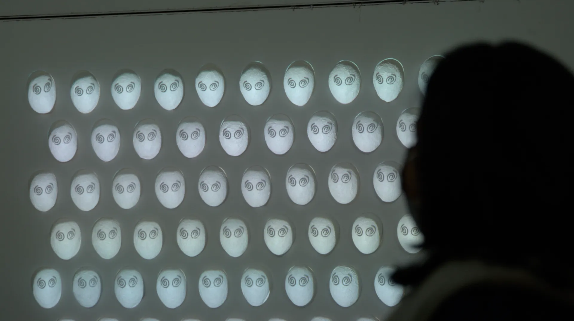 Visitor Viewing Spiral Eyes Projection